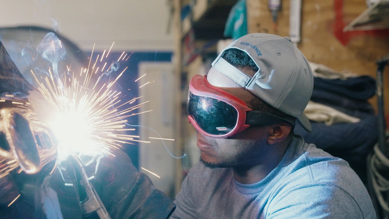Technician welding at Xcellence Body Works